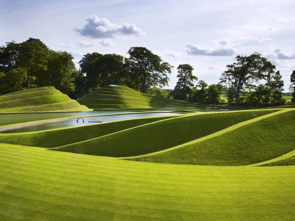 Beautiful green gardens with a lake in the middle. It looks magical.