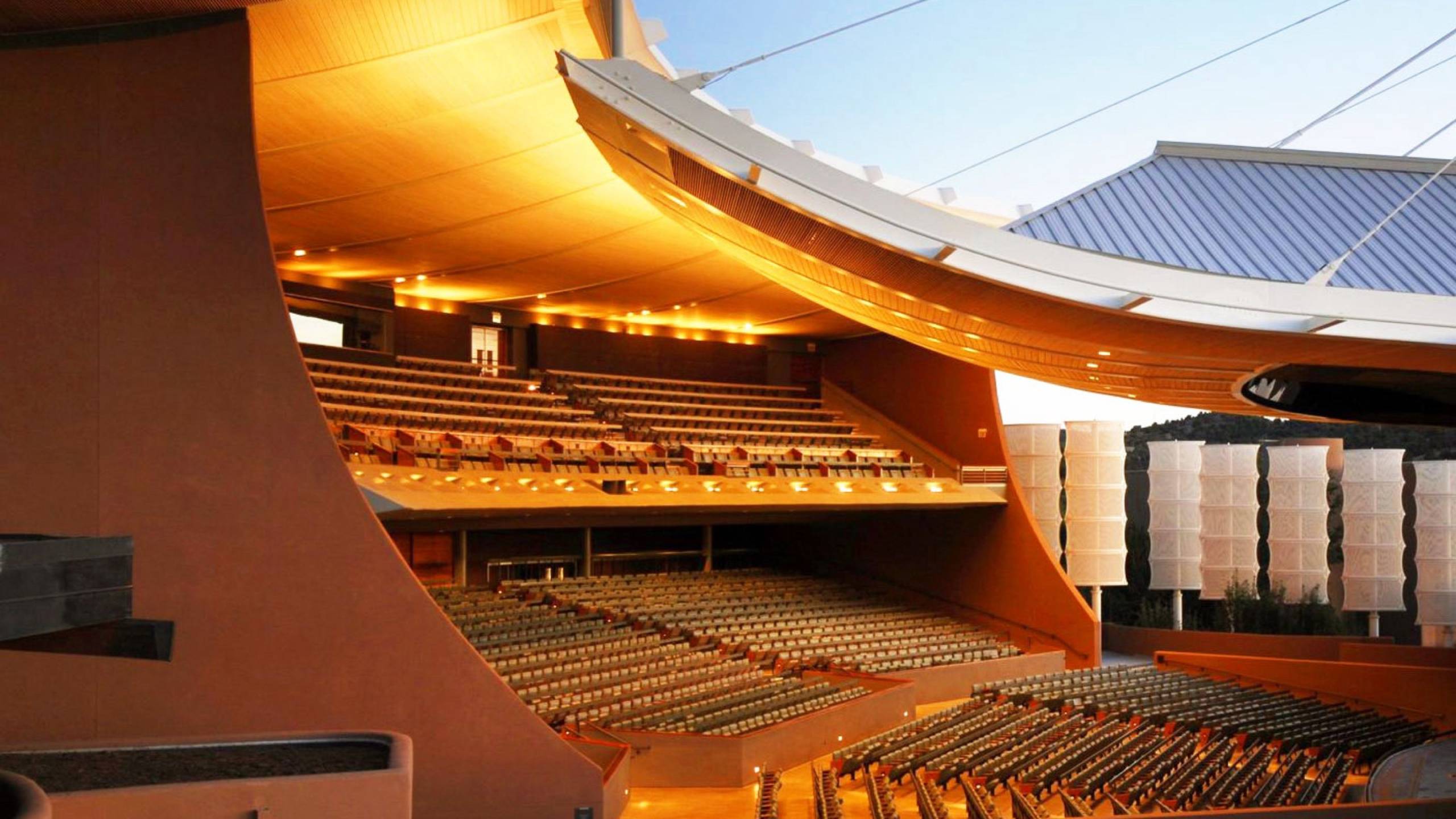 Picture inside the Santa Fe Opera, a wide angle shot with a beautiful orange hue.